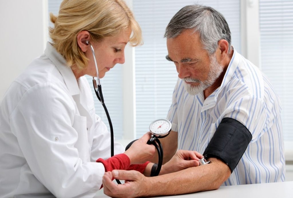 Immigration exam clinic open now Houston conducting blood pressure screening for USCIS health exam requirements.