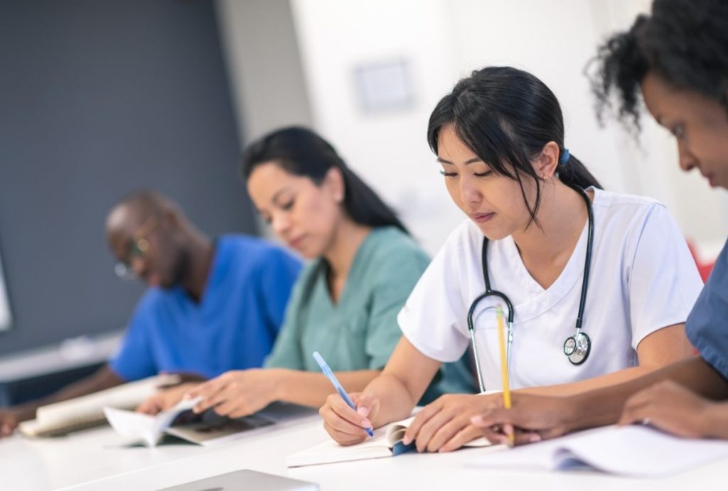 Future immigration doctors Houston studying clinical procedures and exam prep for USCIS medical certification.