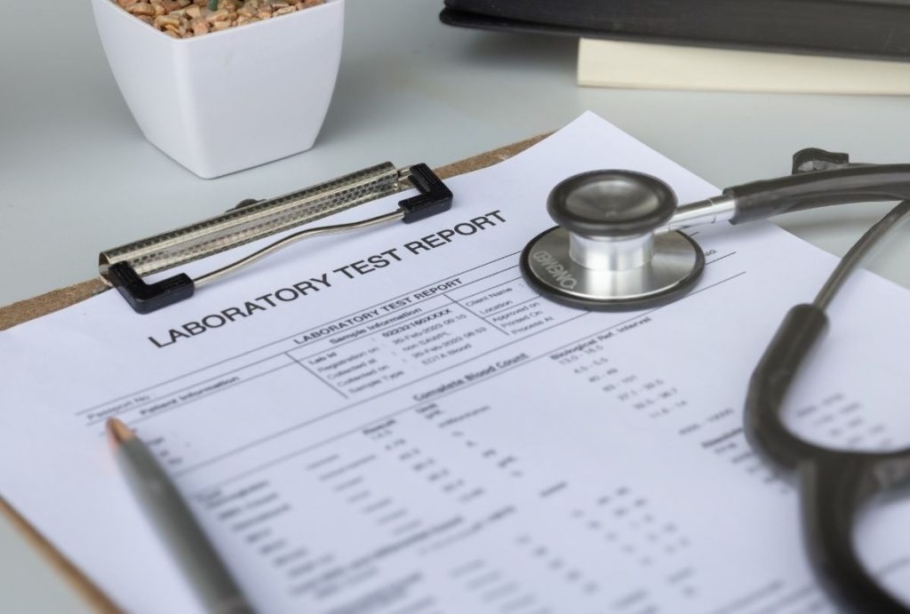 Laboratory test report with stethoscope and pen prepared for immigration medical exam same day appointment Houston patients.