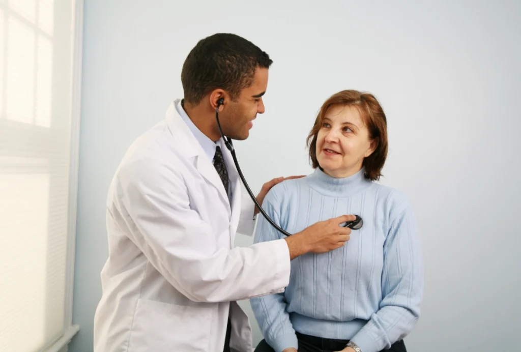 Immigration doctor Houston performing chest exam during medical checkup for USCIS health clearance evaluation.