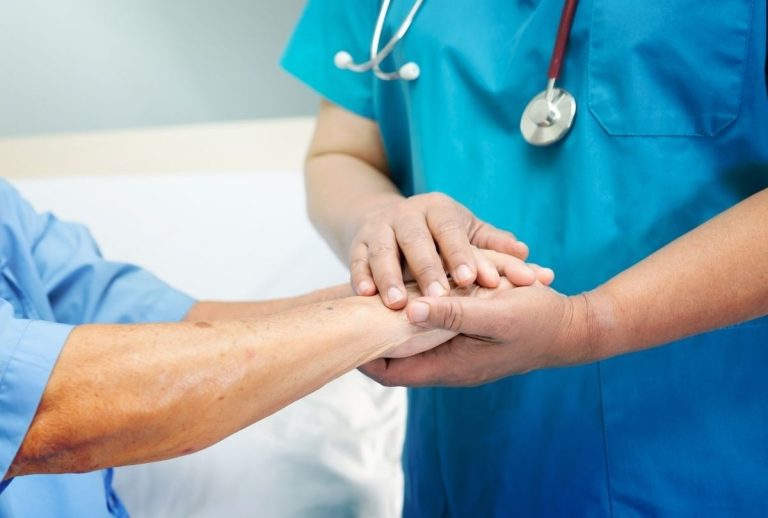 Healthcare professional offering support to patient during low cost immigration medical exam Houston with compassionate care.