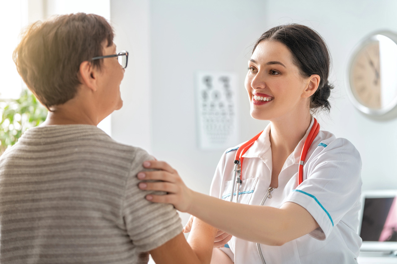 Immigration medical physical Houston clinic doctor reassuring patient while reviewing health history during immigration screening appointment