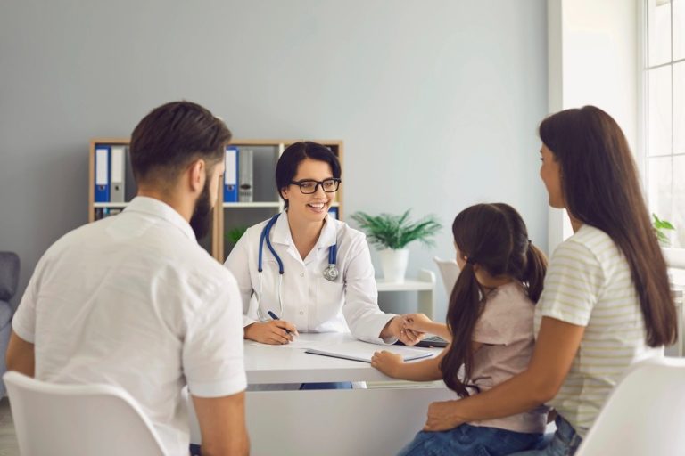 Cheapest immigration medical exam Houston for families consulting with friendly doctor in modern clinic office