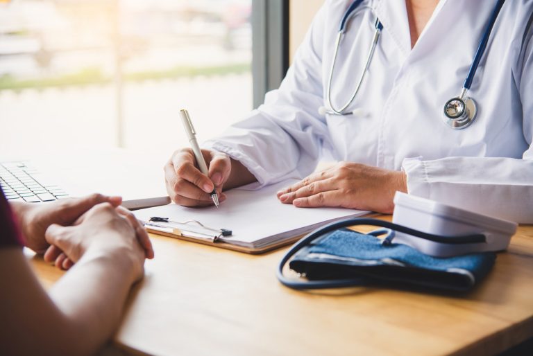 Doctor checking blood pressure for an immigration medical exam Houston during a civil surgeon health screening appointment.
