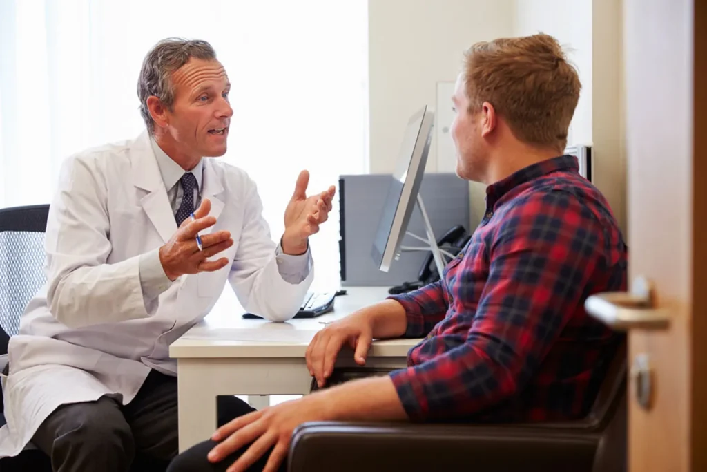 A certified civil surgeon explains the necessary next steps after a thorough USCIS immigration medical exam to a patient.
