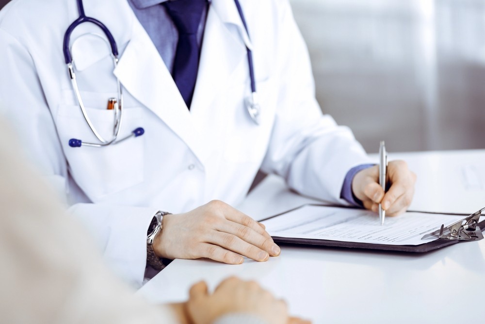 Houston green card medical exam doctor reviewing patient health history 