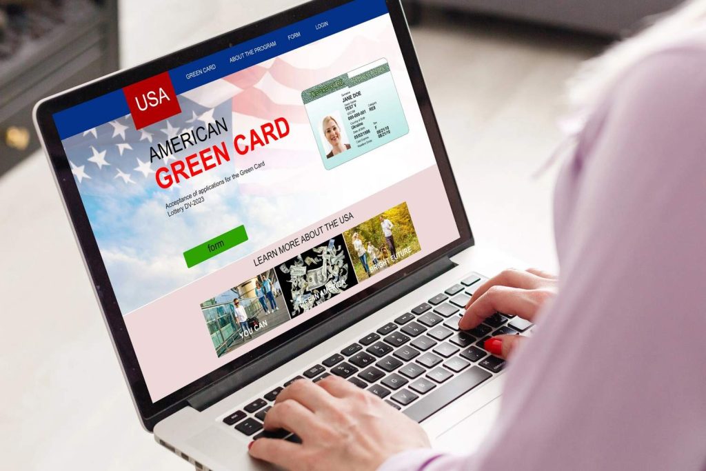 Person typing on a laptop to register for a medical exam with a USCIS civil surgeon Houston for a green card application. 