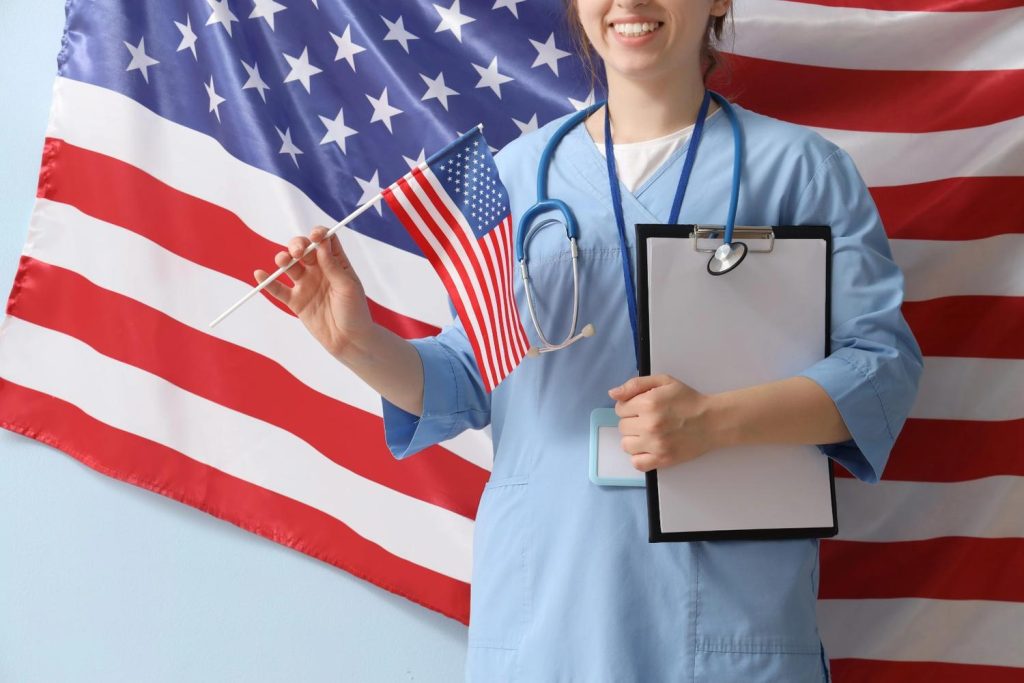 A female healthcare professional holding an American flag and clipboard, representing a USCIS approved doctor Houston. 