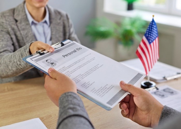 Professional candidate submitting a personal bio for review during an appointment with a top-rated immigration doctor Houston.