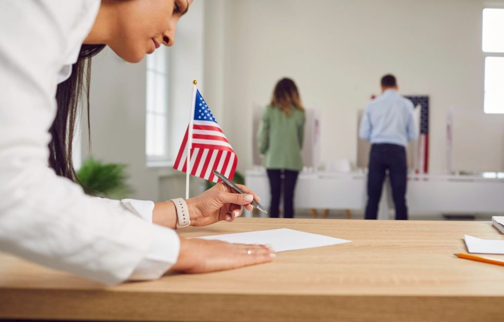 Applicant filling out official medical forms with expert guidance from a certified immigration doctor Houston clinic. 