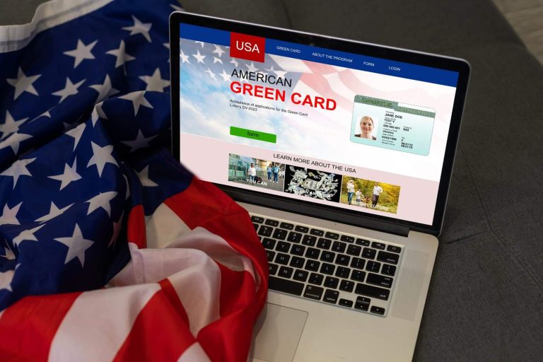 Laptop showing a green card application form next to a US flag, highlighting the USCIS civil surgeon Houston process.